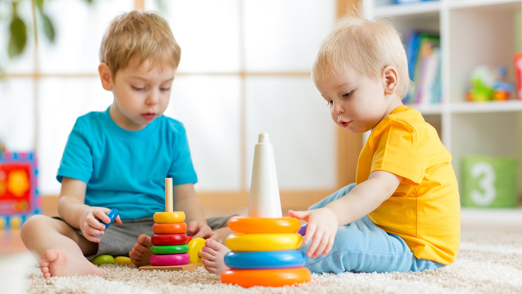 Two brothers are playing in nursery home