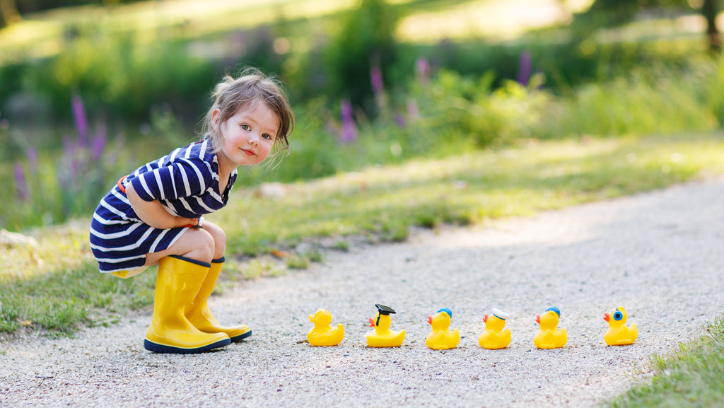 A cute little baby play with duck toys